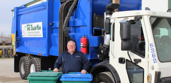 The Trash Man Photo In Front of Their Dumpster Truck